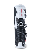Botas Alpinestars 2026 Tech 7 Enduro, botas de motocross y enduro, negro y blanco, vista posterior que muestra las placas protectoras de TPU en el talón y la pantorrilla, logotipo de Alpinestars en rojo sobre el panel superior blanco y sistema de cierre con hebillas plateadas, diseñadas para conducción off-road de alto rendimiento