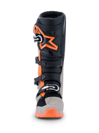 Botas Alpinestars 2026 Tech 7 Enduro, botas de motocross y enduro, negro, gris cálido y naranja flúor, vista frontal con un gran logotipo de estrella naranja en la espinilla, sistema de cierre de múltiples hebillas y paneles protectores robustos para rendimiento off-road