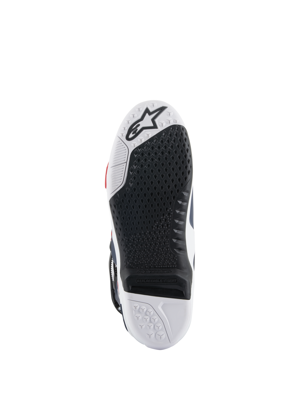 Suela de las botas Alpinestars Tech 10 Supervented, vista inferior con diseño de doble compuesto en blanco y negro, textura de agarre en forma de panal, inserto central reemplazable y logotipo de Alpinestars en relieve, optimizada para el rendimiento en estriberas de motocross.