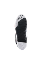 Suela de las botas Alpinestars Tech 10 Supervented, vista inferior con diseño de doble compuesto en blanco y negro, textura de agarre en forma de panal, inserto central reemplazable y logotipo de Alpinestars en relieve, optimizada para el rendimiento en estriberas de motocross.