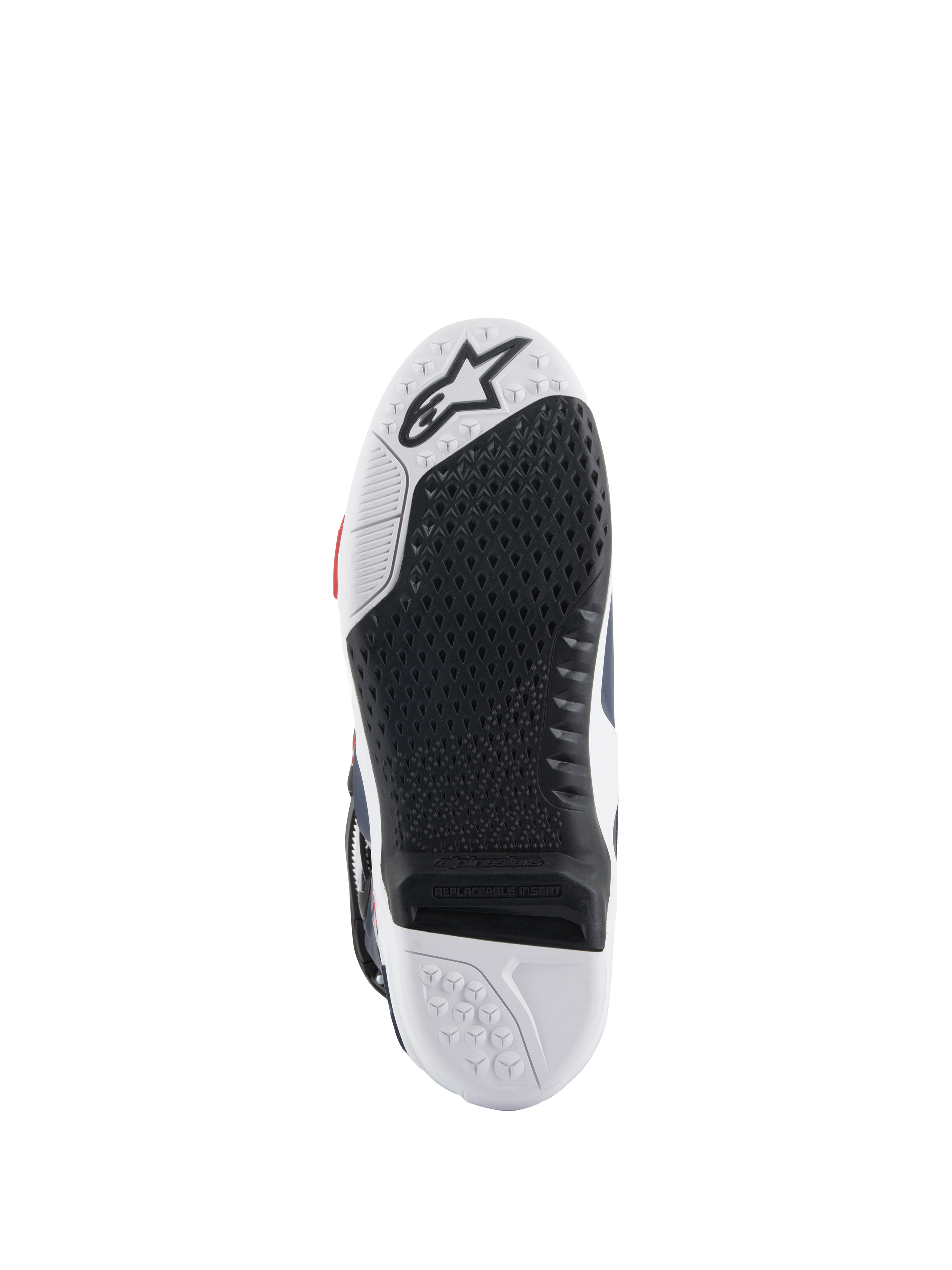 Suela de las botas Alpinestars Tech 10 Supervented, vista inferior con diseño de doble compuesto en blanco y negro, textura de agarre en forma de panal, inserto central reemplazable y logotipo de Alpinestars en relieve, optimizada para el rendimiento en estriberas de motocross.