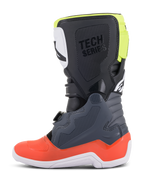 Botas Alpinestars Youth Tech 7S, botas de motocross, color gris oscuro con detalles en rojo y amarillo fluorescente, vista de perfil lateral, suela blanca, marca 'TECH SERIES' y paneles protectores de TPU duraderos.