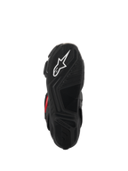 Botas Alpinestars SMX-6 V3 Drystar®, vista de la suela, caucho negro texturizado para agarre, con el logotipo de la estrella blanca y la marca Alpinestars en relieve, calzado de motociclismo de alto rendimiento.