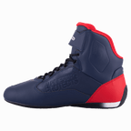 Zapatilla de moto Alpinestars Austin, azul marino y rojo brillante, vista de perfil que muestra la parte superior de microfibra con detalles en rojo en el talón y el cuello, cordones negros, marca grabada 'Alpinestars Protects', calzado de motociclismo de caña alta