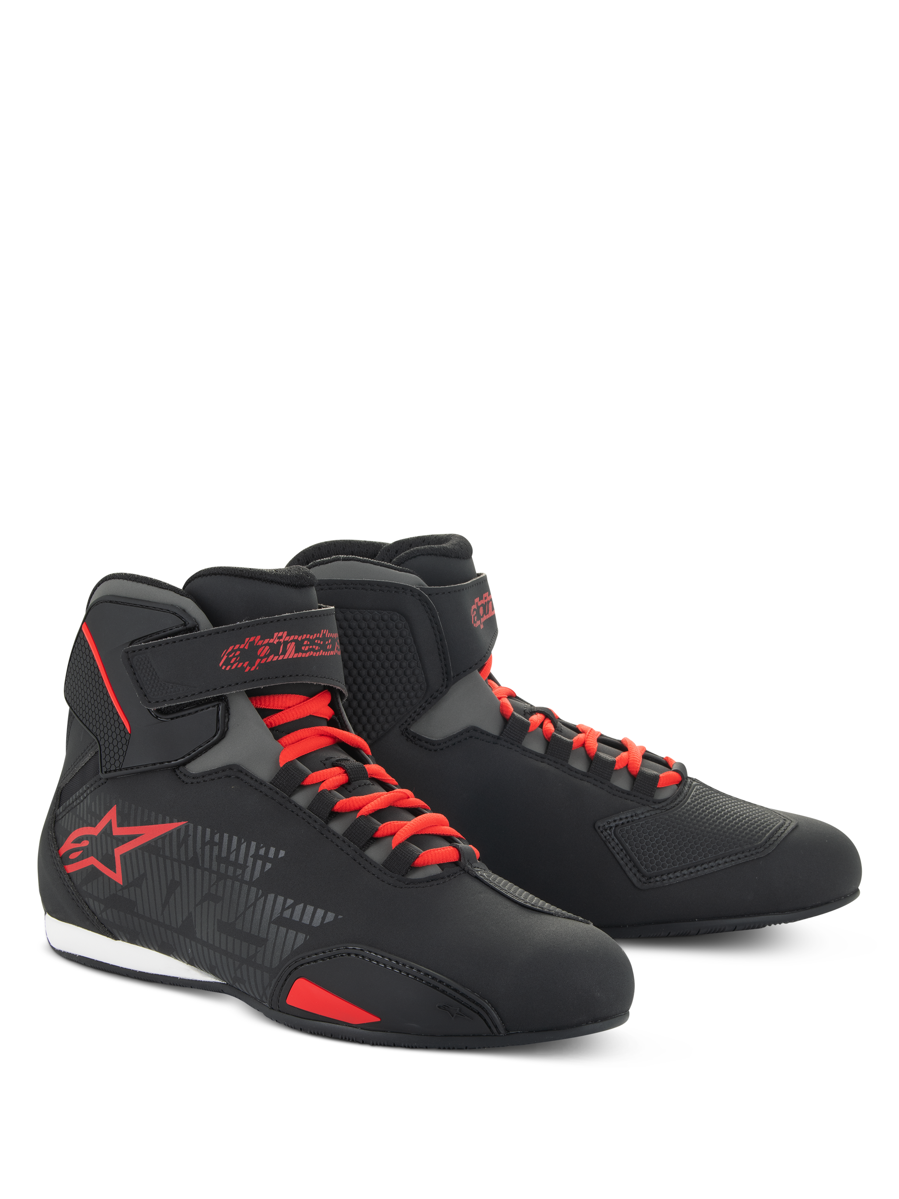 Zapatos Alpinestars Sektor, calzado de moto de corte bajo, negro y rojo brillante, con sistema de cordones rápidos rojos, correas en el tobillo y llamativo logo de estrella roja, construcción de microfibra para conducción en carretera y deportiva.