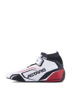 Zapatillas Alpinestars Tech-1 T V3 FIA, calzado profesional para automovilismo, blanco, negro y rojo, vista de perfil con logotipo ASTARS en cuero perforado, cuello ignífugo negro y detalles rojos en el talón, diseño de alto rendimiento para deportes de motor.