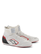 Alpinestars Supertech Shoes, Auto Racing Footwear, White Red and Black, featuring a fully knitted upper, black carbon fiber heel cup, and red accents on the sole and logo, professional motorsport shoes with FIA/SFI certification labels on the tongue.