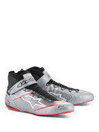 Alpinestars Tech-1 Z V3 Shoes FIA, zapatos de automovilismo, plata oscuro con detalles en negro y rojo, parte superior de cuero plateado metálico con sistema de cordones rápidos negros, correa de tobillo con la marca y detalles de suela roja delgada.