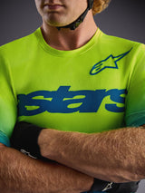 Maillot Alpinestars A-Dura ASTARS 2.0 Yellow Fluo, camiseta MTB de manga corta con gráficos azules y tejido elástico.