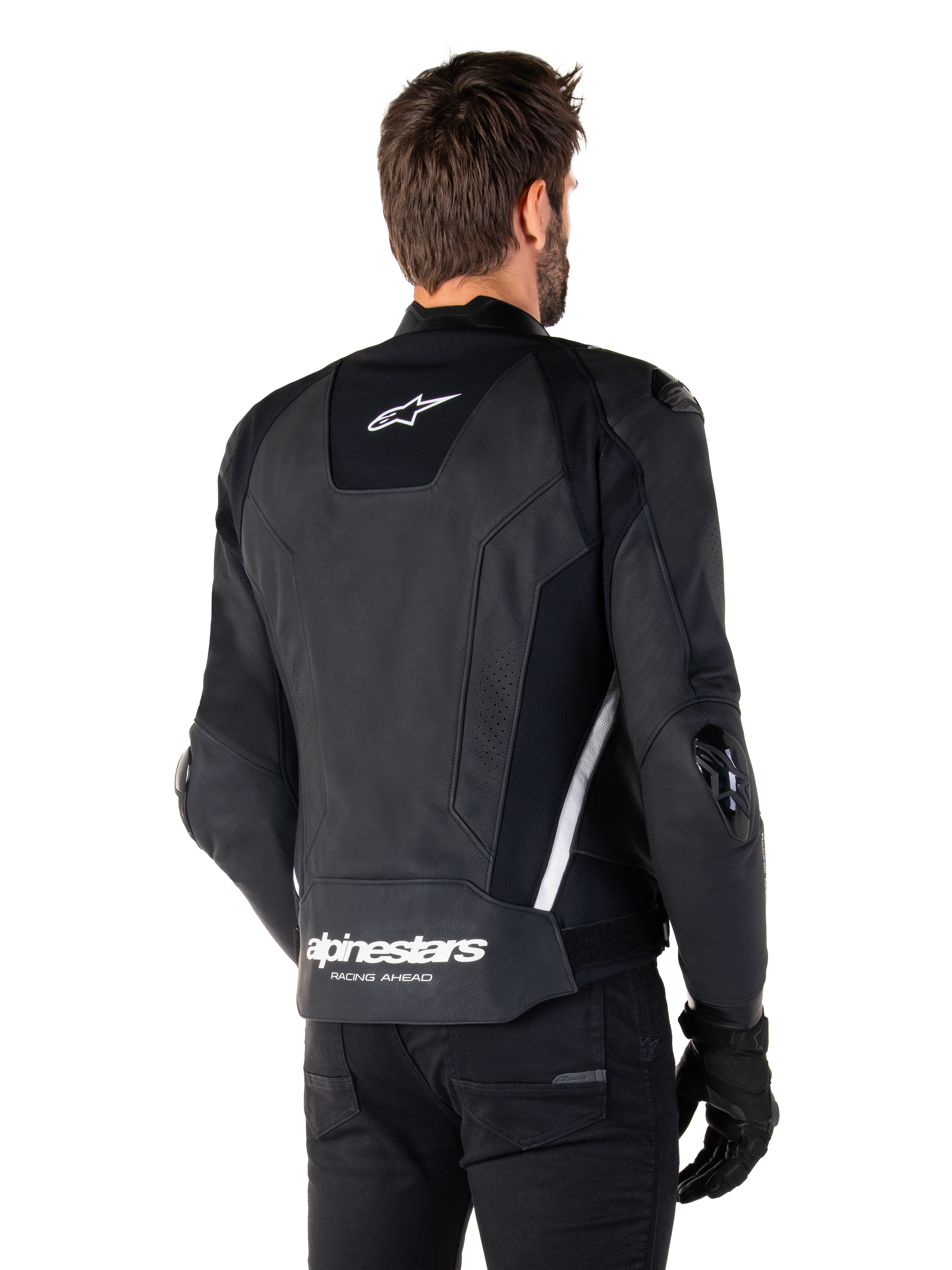 Chaqueta de cuero Alpinestars Missile V3, vista trasera, negro y blanco, con el logotipo de la estrella de Alpinestars en la parte superior de la espalda y el nombre de la marca en la parte inferior, deslizadores protectores en codos y hombros, equipamiento de carreras de cuero premium