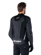 Alpinestars Missile V3 Airflow Leather Jacket, Black and White, rear view featuring perforated leather and mesh panels for maximum ventilation, white Alpinestars branding on lower back and star logo on neck, worn with black riding gear, premium racing sport design.
