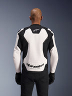 Alpinestars GP Force V2 Leather Jacket, White and Black, back view on a model, featuring a white leather panel with black side accents, Alpinestars logo at the nape and 'RACING AHEAD' branding on the lower back, sport motorcycle racing jacket