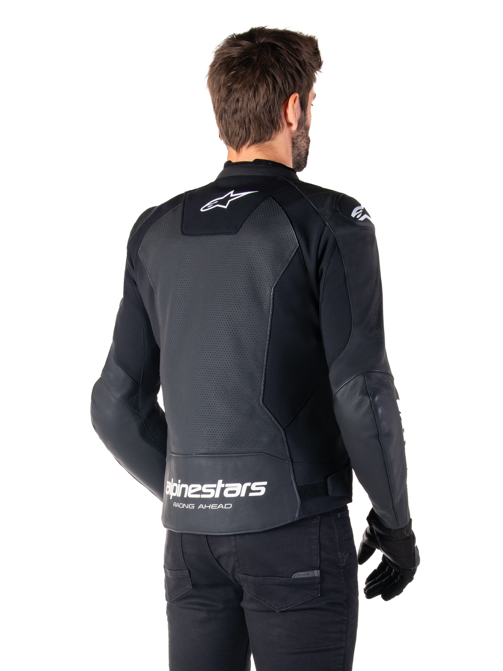 Chaqueta de cuero Alpinestars Faster V3 Airflow, negro y blanco, vista posterior en un modelo, con espalda de cuero perforado para ventilación, logos Astars blancos en la parte superior de la espalda y en la parte inferior de la cintura con el texto 'Racing Ahead', diseño deportivo con paneles elásticos para motociclismo.