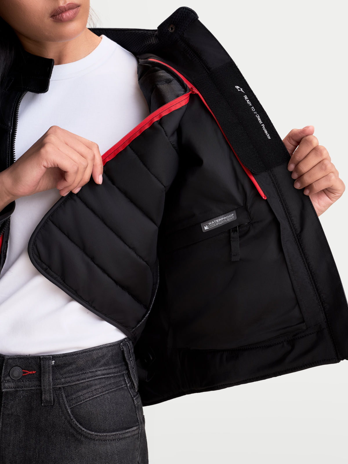 Alpinestars Revea Women Leather Jacket, urban motorcycle leather jacket, women's fit, black, showing close-up of removable thermal vest and waterproof internal compartment, worn by a model