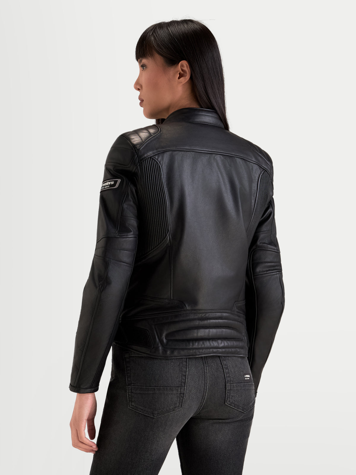 Alpinestars Revea Women Leather Jacket, urban motorcycle leather jacket, black, rear view showing premium full-grain bovine leather construction and shoulder padding worn by a model