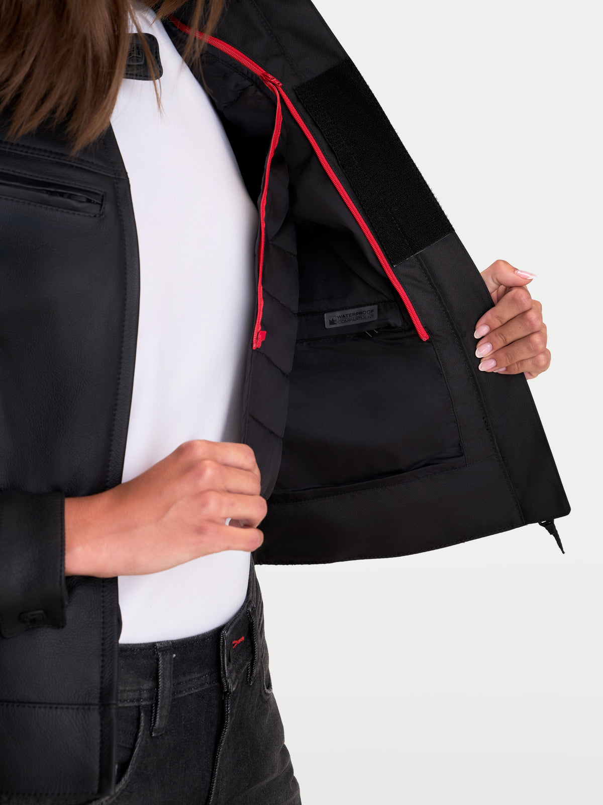 Alpinestars Stella Maver-X Leather Jacket, women's urban motorcycle jacket, black with red zip accents, close-up view showing the internal waterproof compartment and quilted fixed lining