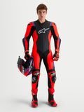 Alpinestars Missile V3, mono de cuero de una pieza para moto, negro, rojo flúor y morado, con protección certificada y casco a juego
