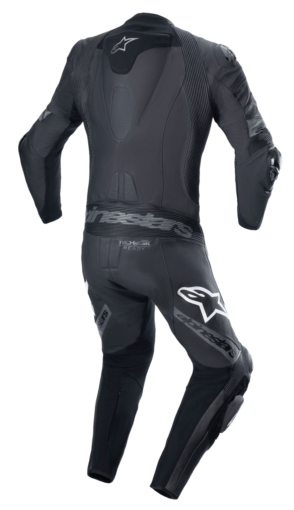 Mono de cuero Alpinestars Missile V2 Ward de una pieza, negro y gris metálico, vista trasera con joroba aerodinámica, paneles elásticos de acordeón en la parte baja de la espalda y los hombros, marca Alpinestars en los muslos y logotipo Tech-Air Ready