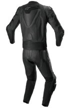 Mono de cuero de 2 piezas Alpinestars Missile V2, traje de cuero para carreras, totalmente negro, vista trasera que muestra la joroba aerodinámica con el logotipo de la estrella blanca, paneles elásticos de acordeón en la cintura y los hombros, y detalles de cuero perforado para conducción de alto rendimiento en moto