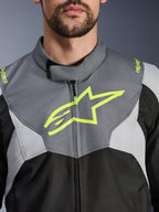Alpinestars T-Jaws V4 Waterproof Jacket, Black Ice Gray and Dark Gray, close-up view of the chest and collar, featuring a bold neon yellow Alpinestars star logo and branding on the shoulders, durable textile material for motorcycle riding