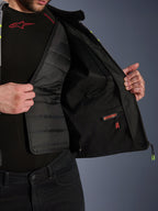 Alpinestars T-Jaws V4 Waterproof Jacket interior view, showcasing the removable black quilted thermal liner and a red-labeled waterproof inner compartment, featuring mesh lining and premium motorcycle protective gear construction.