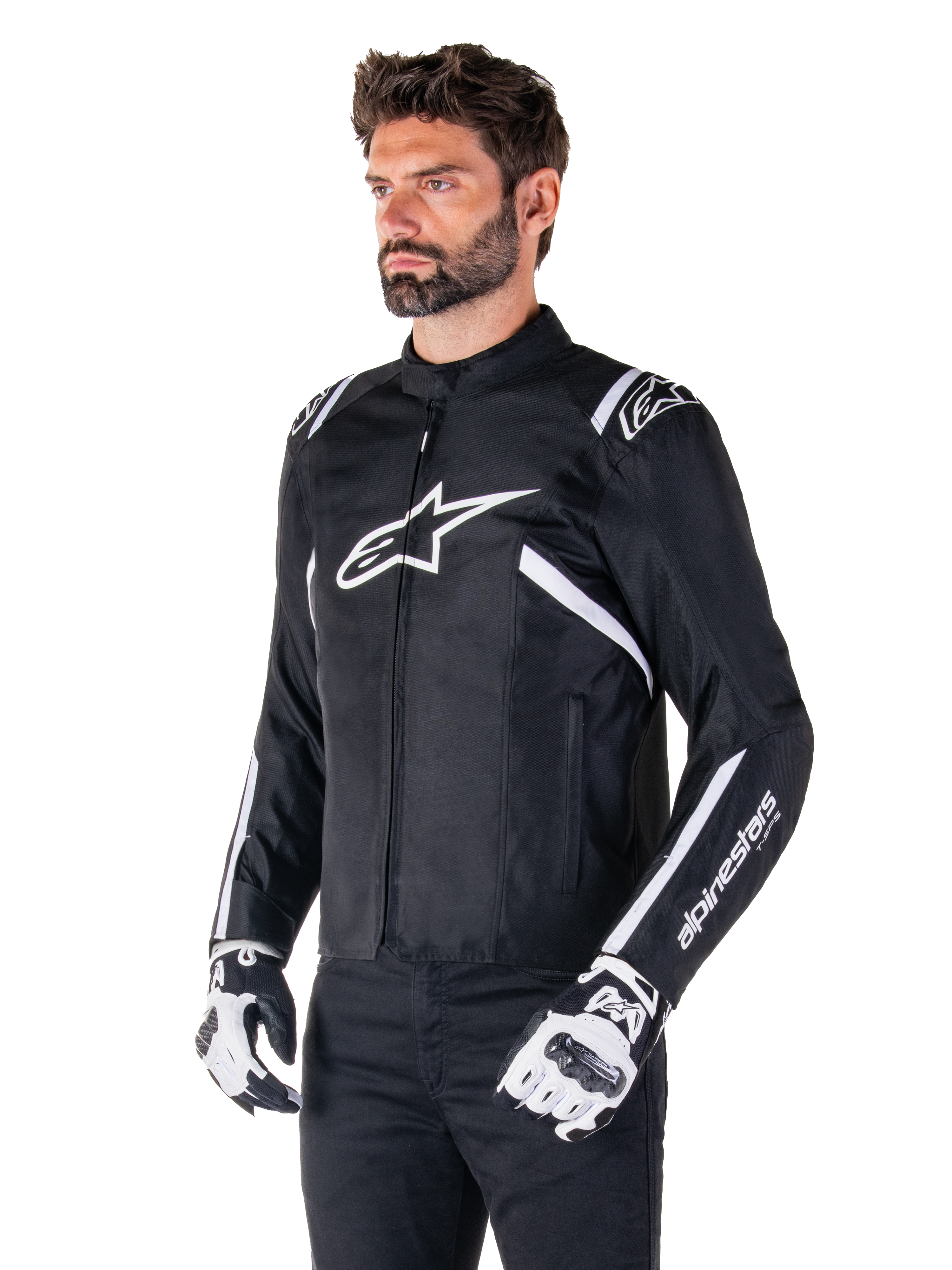 Alpinestars T-SPS V2 Waterproof Jacket, Black and White, worn by male model with matching motorcycle gloves, sport-cut textile jacket with white Alpinestars logos on chest and shoulders, 'alpinestars T-SPS' branding on sleeve, sleek race-inspired motorcycle gear