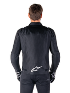 Alpinestars T-SPS V2 Waterproof Jacket, Black and White, back view showing white Alpinestars logo on lower back, worn with black pants and gloves, sport cut textile motorcycle jacket