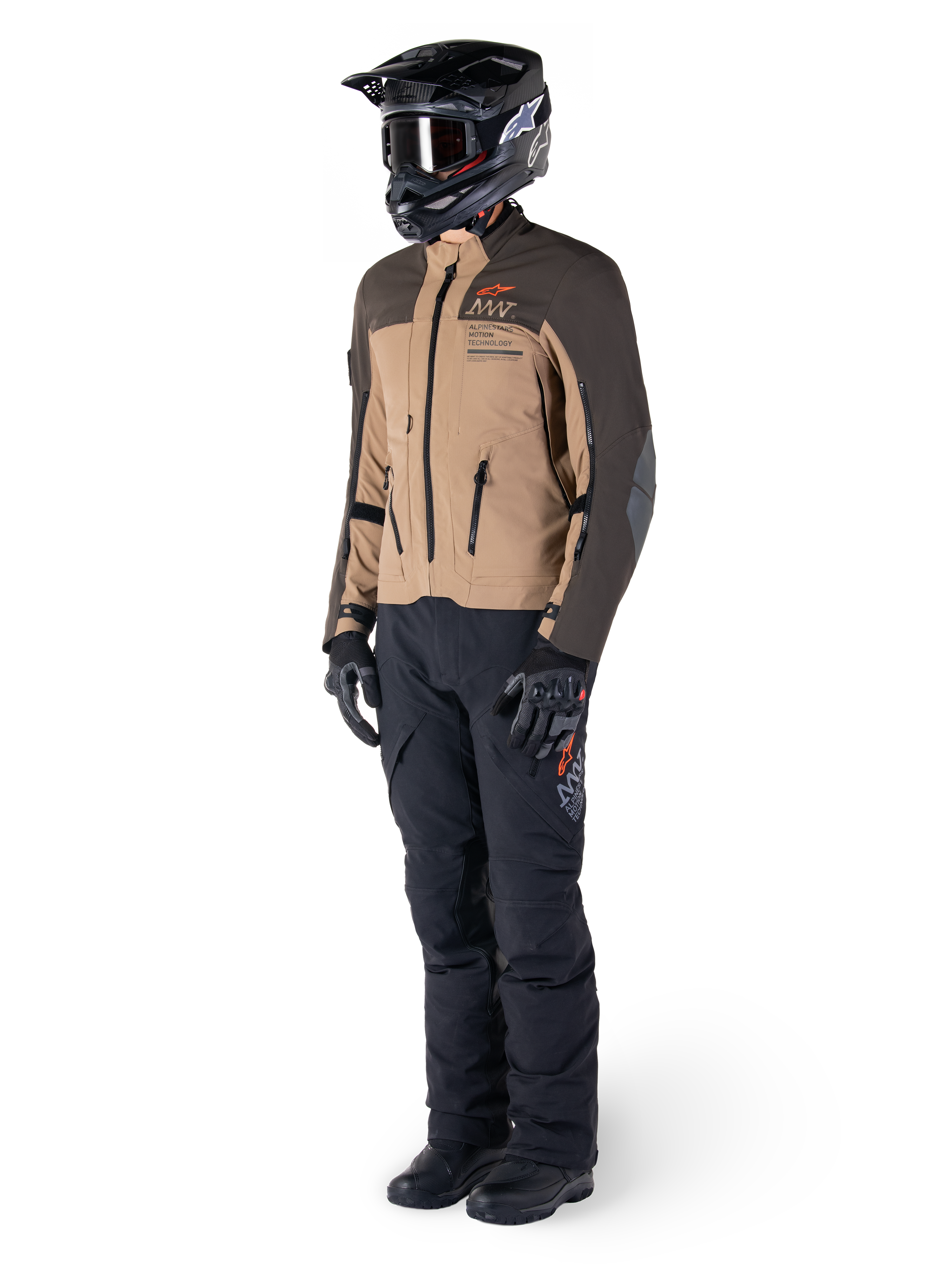 Adventure rider wearing complete gear, Alpinestars AMT-8 Stretch Drystar® XF Jacket in Dark Brown and Dark Khaki, paired with black adventure pants, black helmet, gloves, and boots, featuring orange AMT branding and technical ventilation zippers for long-range touring