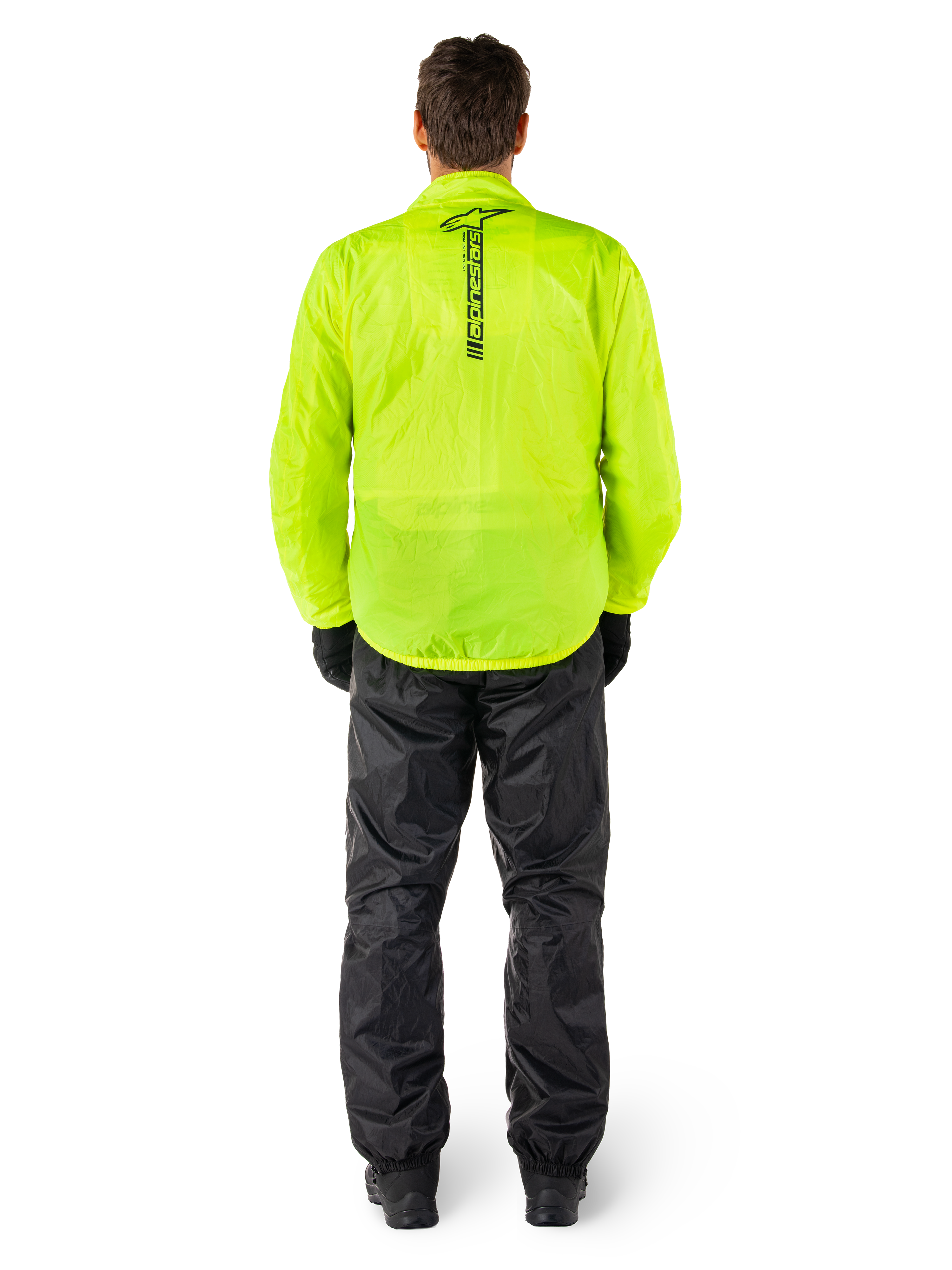Chaqueta y pantalones Alpinestars Hurricane Rain V2, traje de lluvia impermeable para moto, chaqueta amarillo flúor brillante con marca negra vertical en la espalda, pantalones negros, material textil ligero diseñado para protección en climas húmedos