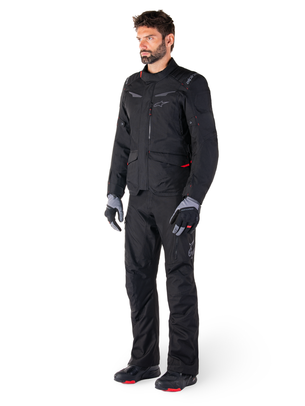 Alpinestars ST-1 Waterproof Jacket, Black, adventure touring jacket with red accents, worn with matching black pants, gloves and boots, full body view of rider in complete all-weather gear set