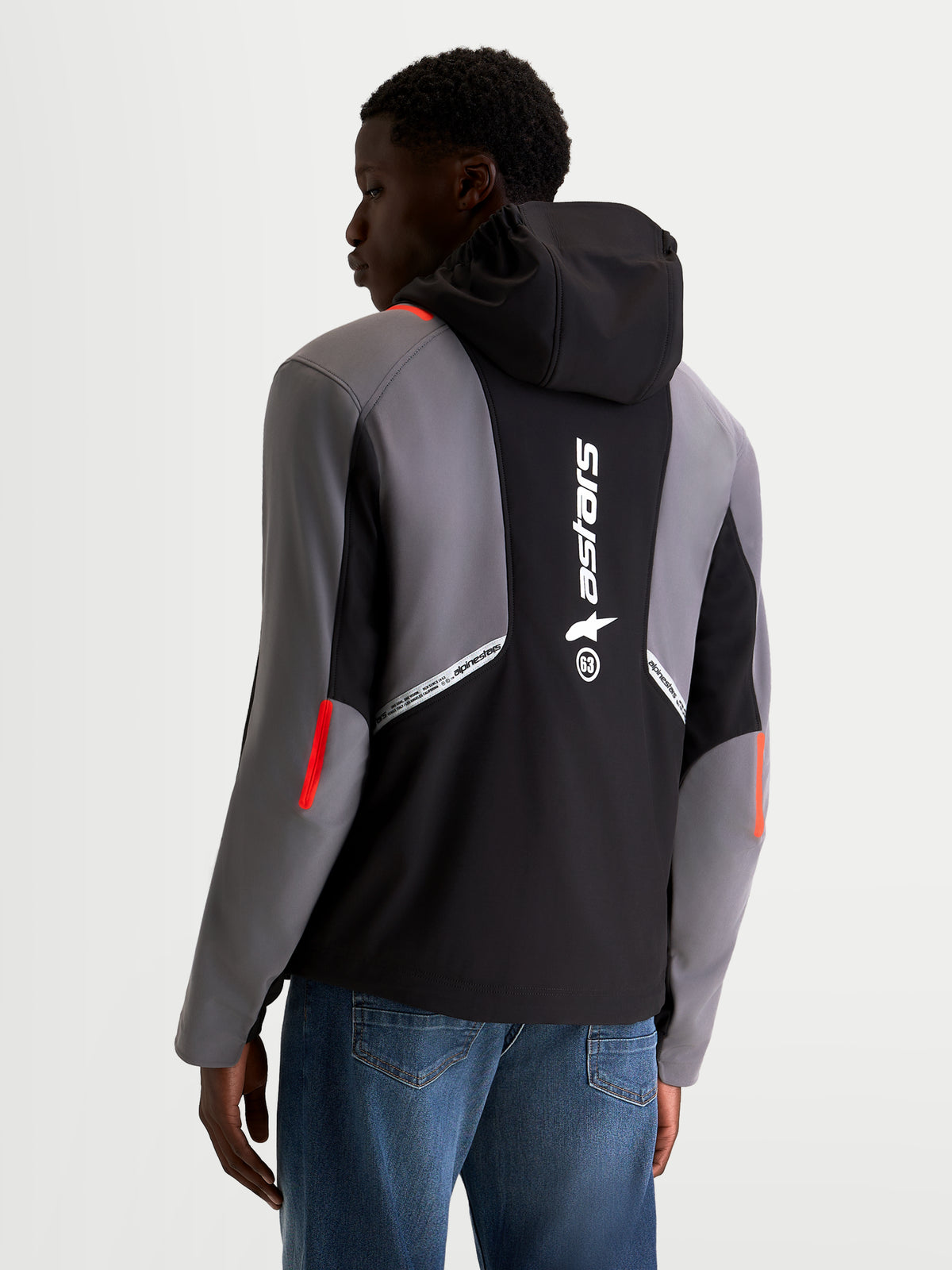 Alpinestars C 5 Drystar Chaqueta, chaqueta de moto urbana softshell para hombre, negro y gris oscuro, vista trasera en un modelo que muestra la capucha integrada, gran logotipo de Alpinestars en la espalda y construcción textil impermeable