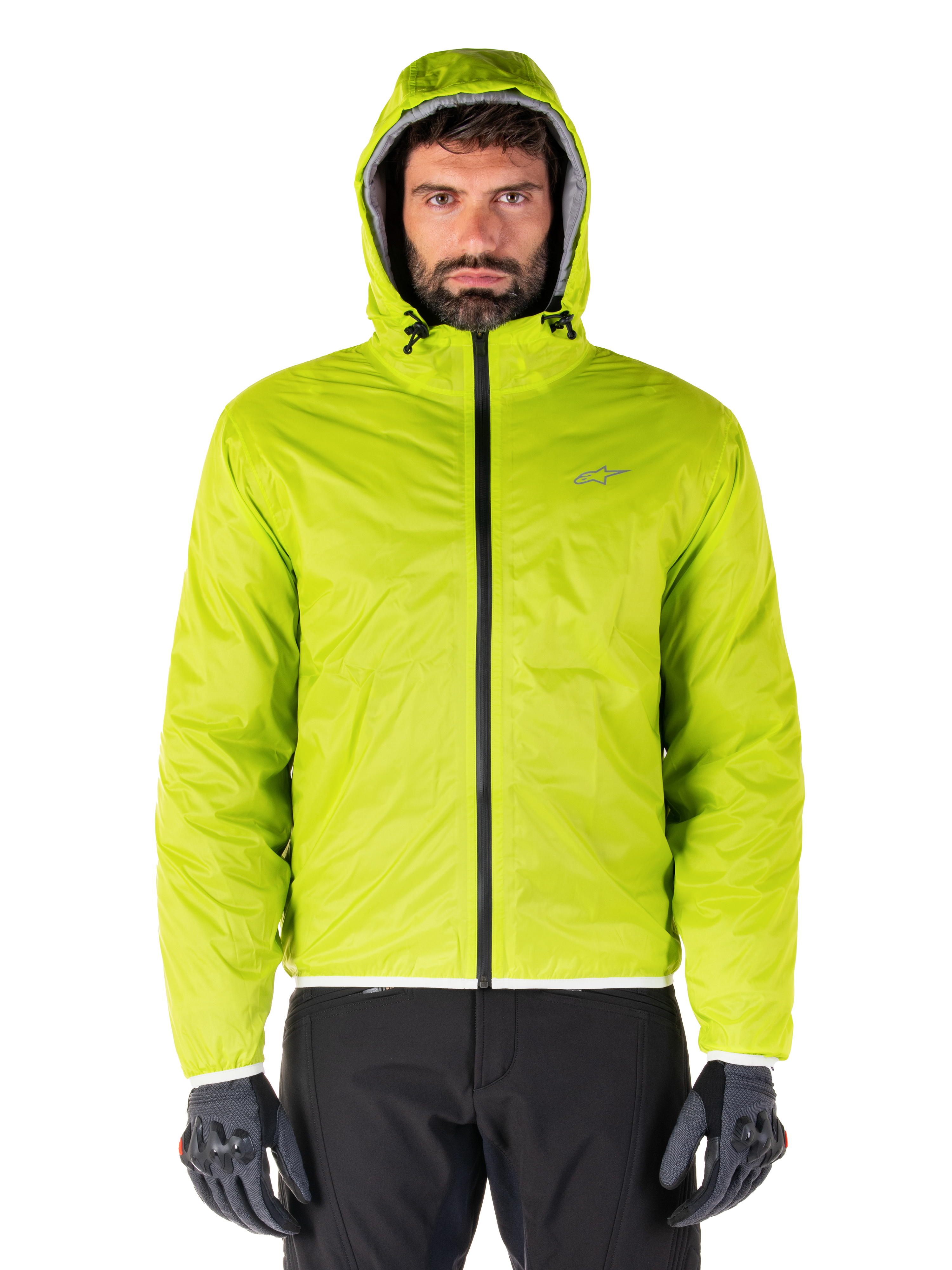 Alpinestars Mohobbs Waterproof Jacket, Lime Punch packable raincover, bright lime green hooded shell worn with black riding pants and gray motorcycle gloves, urban moto-streetwear style.