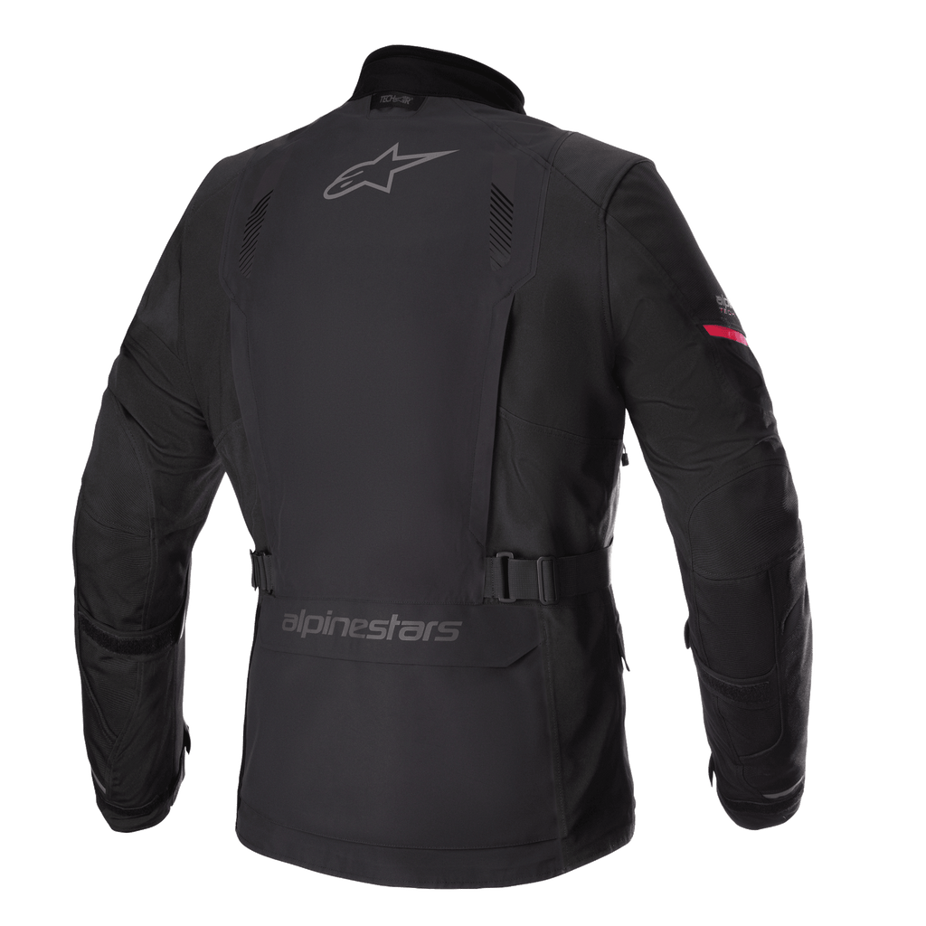 Alpinestars Monteira Drystar® XF Jacket, Adventure Touring Motorcycle Jacket, Black with Bright Red sleeve detail, rear profile showing grey Alpinestars logos, adjustable waist belt, and durable waterproof textile shell