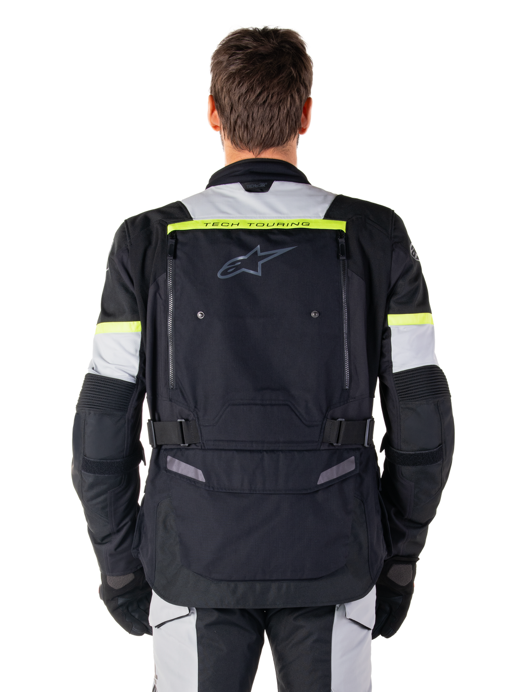 Chaqueta Alpinestars Bogotá Pro Drystar®, chaqueta de moto para touring de aventura, negro, gris hielo y amarillo flúor, vista posterior que muestra la marca 'TECH TOURING' en una franja amarilla fluorescente, amplio panel de ventilación en la espalda y correas de cintura ajustables, equipamiento técnico para todas las estaciones