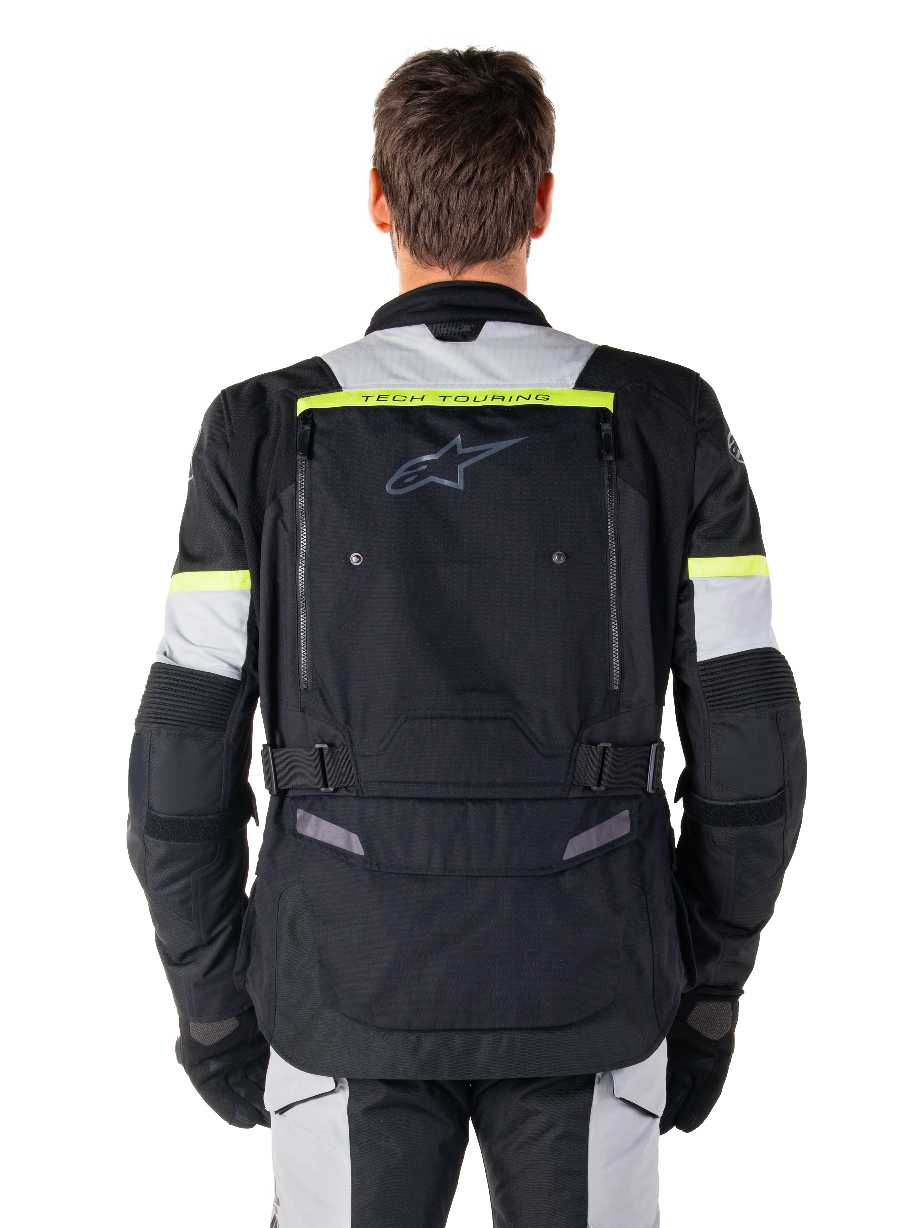 Chaqueta Alpinestars Bogotá Pro Drystar®, chaqueta de moto para touring de aventura, negro, gris hielo y amarillo flúor, vista posterior que muestra la marca 'TECH TOURING' en una franja amarilla fluorescente, amplio panel de ventilación en la espalda y correas de cintura ajustables, equipamiento técnico para todas las estaciones
