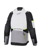 Chaqueta Alpinestars Stella Andes V4 Drystar®, chaqueta de moto de aventura para mujer, gris hielo, gris oscuro y negro con detalles en amarillo flúor, vista trasera que muestra el gran bolsillo posterior y la marca Alpinestars