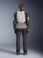 Woman rider from the back wearing the Alpinestars Stella Andes V4 Drystar® Jacket, Ice Gray, Dark Gray, and Black with Yellow Fluo accents, featuring a large rear storage pocket and Alpinestars logo, paired with matching black adventure pants, all-weather motorcycle touring gear