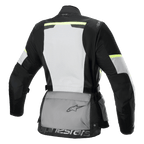 Chaqueta Alpinestars Stella Andes Air Drystar®, chaqueta de moto touring para mujer, vista trasera, gris hielo, gris oscuro y negro, con un gran panel de malla blanca en la espalda, bolsillo trasero gris con logo, detalles amarillos de alta visibilidad y construcción textil para flujo de aire y protección.