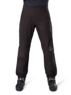 Alpinestars AMT-8 Stretch Drystar® XF Pant Liner, Black, front view worn with black motorcycle boots, featuring grey star logo and AMT branding on the leg, versatile waterproof and windproof motorcycle apparel