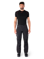 Alpinestars Hyde XT Drystar® Pants, Adventure Touring Motorcycle Pants, Black, worn by a model with a black short-sleeve base layer and black boots, featuring technical stretch material, reinforced knee panels, and ergonomic cargo pockets.