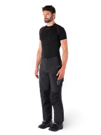 Alpinestars Hyde XT Drystar® Pants, Black adventure touring motorcycle pants worn by a model with a black compression shirt and black boots, featuring technical waterproof construction and Drystar®XF branding.