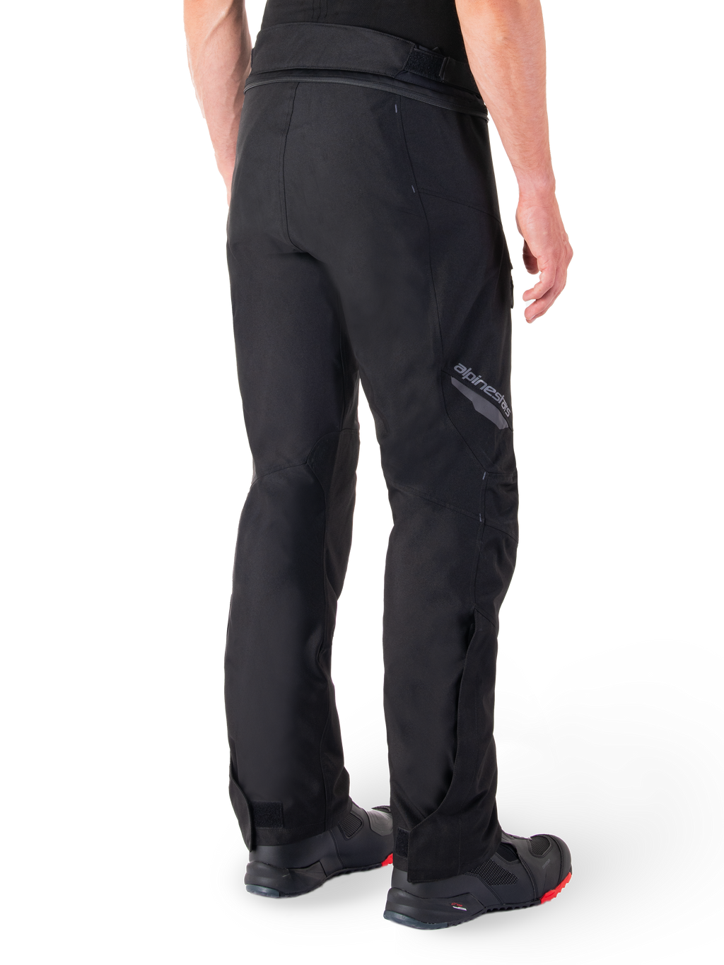 Alpinestars St-1 Waterproof Pants, Black, rear view showing textile construction and Alpinestars branding on the thigh, worn with black motorcycle boots, adventure touring style