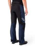 Pantalones impermeables Alpinestars St-1, azul oscuro, negro y rojo brillante, vista trasera con paneles de contraste negros, logotipo reflectante de Alpinestars en el lateral del muslo y ajuste ergonómico para turismo en motocicleta