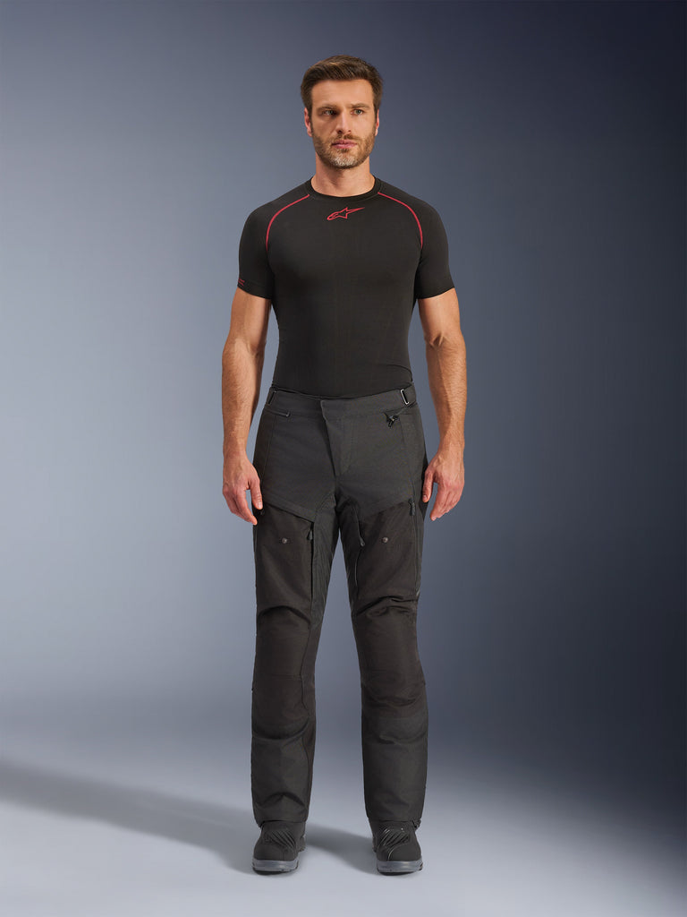 Alpinestars Cusco Drystar Pants, Motorcycle Touring Pants, Dark Gray, Waterproof and Breathable, featuring visible seams and thigh zippers, worn by male rider in fitted position