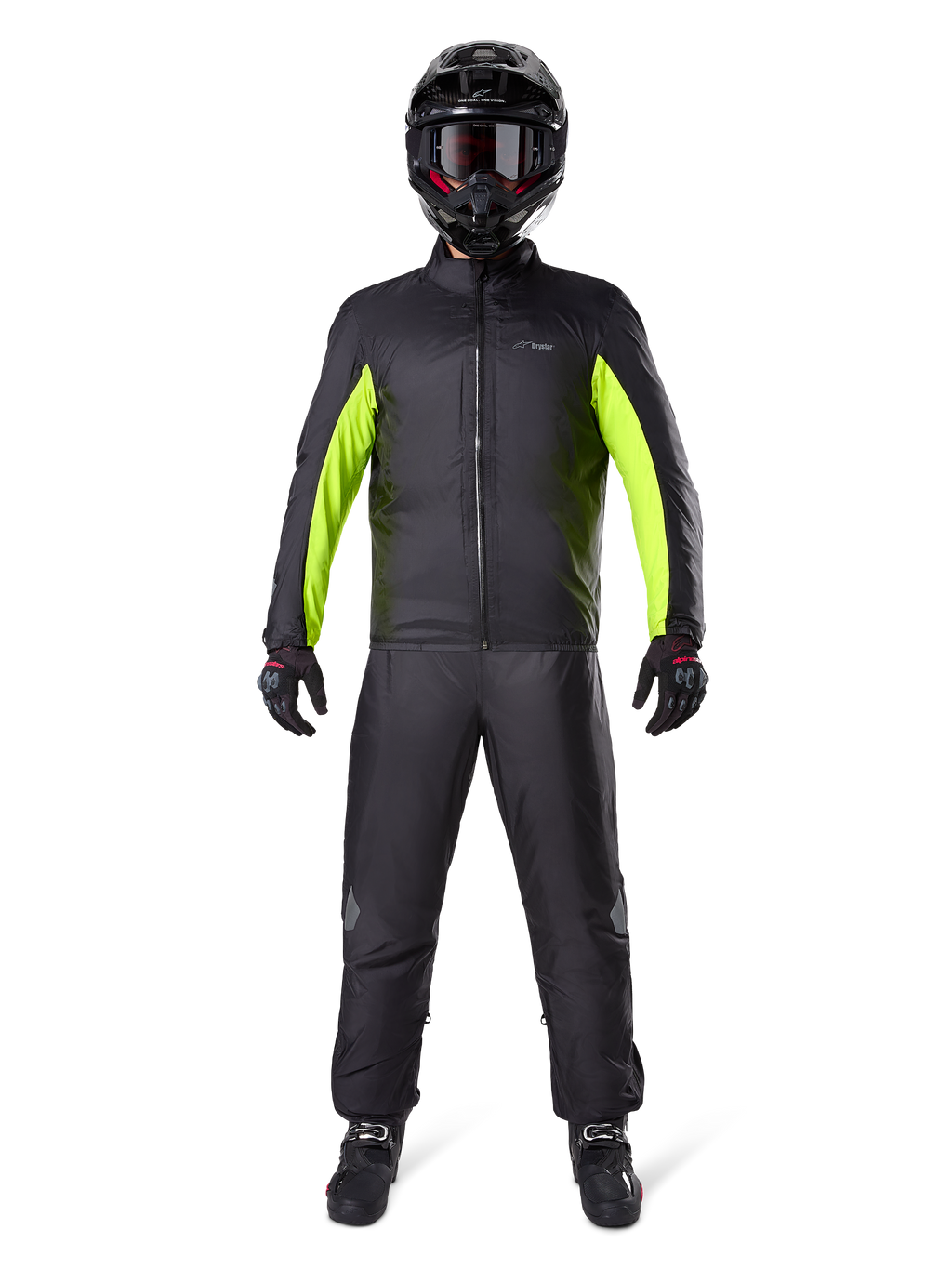 Alpinestars Bogota Pro Drystar 3 Seasons Pants, Black, worn by a motorcycle rider in a full adventure outfit including a black and neon yellow waterproof jacket, black helmet, and riding boots, designed for all-weather touring performance.