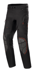 Alpinestars AMT-10R Drystar XF Pants, Adventure Touring Motorcycle Pants, Black with Orange Accents, featuring grey Superfabric knee reinforcements, adjustable waist belt, zippered pockets, and waterproof laminated design