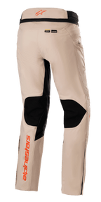 Alpinestars AMT-10R Drystar® XF Pants, Adventure Touring Pants, Pale Brown, rear view featuring large black mesh panels on the back of the knees, orange Alpinestars logos on the waistband and lower leg, and Kevlar and MATRYX material branding.
