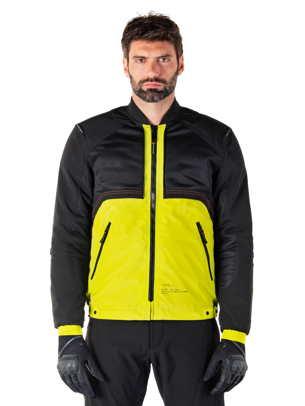Parka impermeable Mootant, chaqueta modular de moto, Lime Punch y negro, vestida por un modelo masculino con guantes y pantalones negros, con la parte inferior en amarillo vibrante y el torso superior y las mangas en negro, diseño utilitario para conducción en cualquier clima