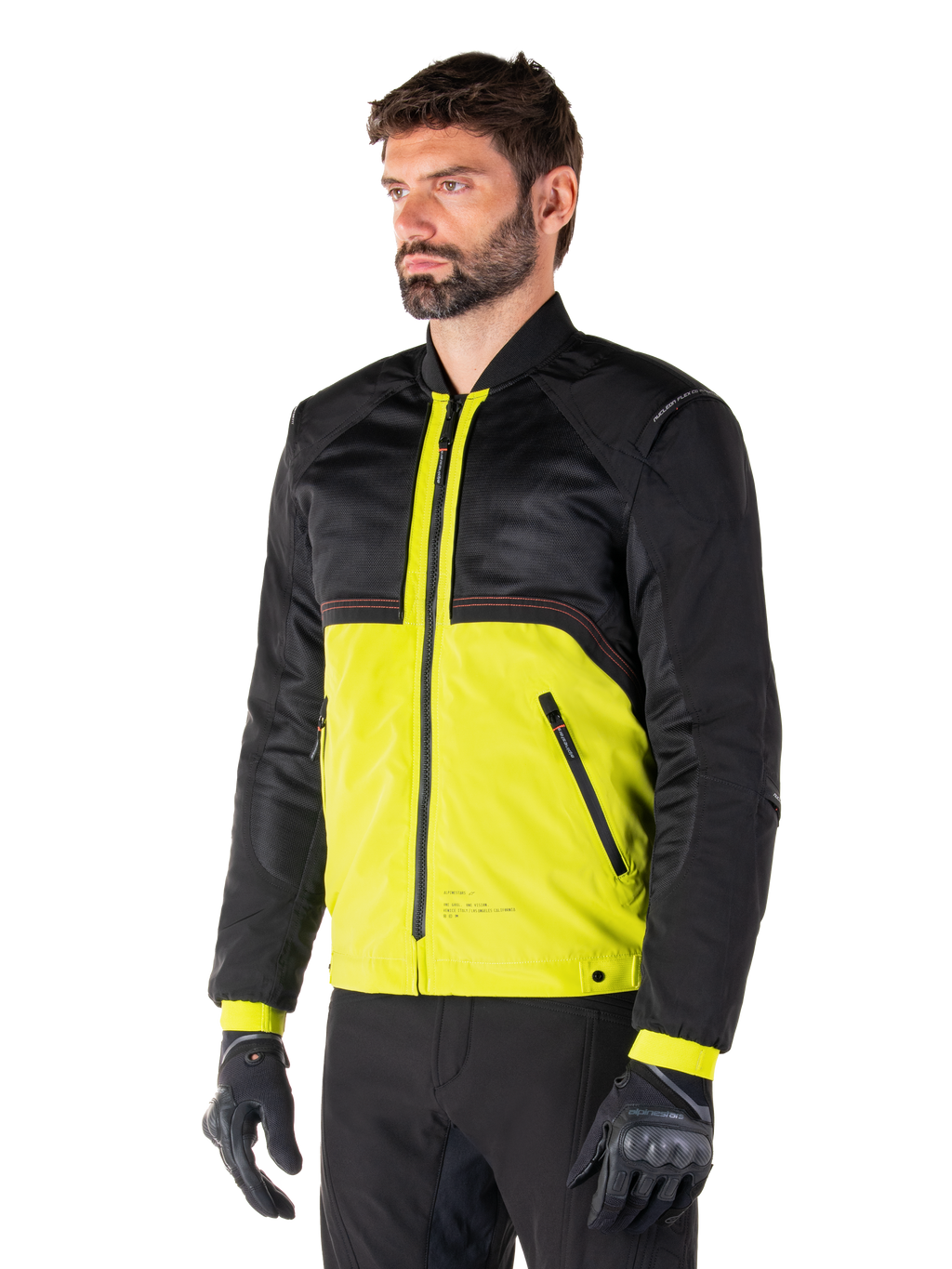 Alpinestars Mootant Waterproof Parka en Lime Punch Black, chaqueta modular de motociclismo con parte superior de malla negra y cuerpo inferior en verde lima vibrante, vestida por un piloto masculino con guantes y pantalones negros, estilo de conducción urbano contemporáneo.