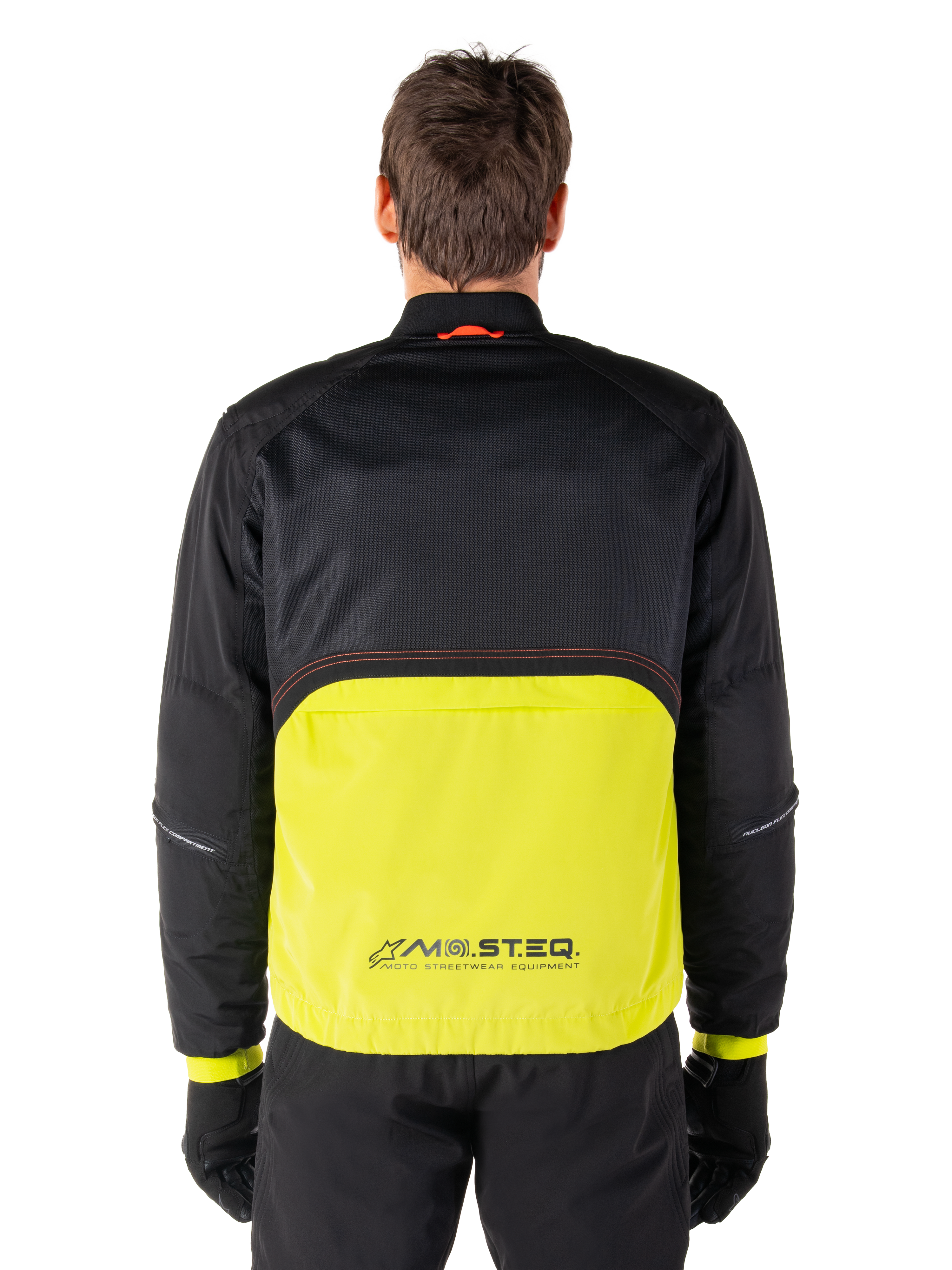 Parka impermeable Alpinestars Mootant, chaqueta de moto, color Lime Punch y negro, vista posterior con parte superior de malla negra para ventilación y sección inferior en color lima con el logo MO.ST.EQ., combinada con pantalones y guantes negros